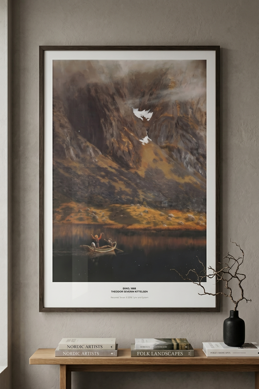 Framed Nordic landscape art of a mountain and lake on a wall above a wooden bench.